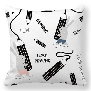 Detailed view of white throw pillow case with hand-drawn rabbit and drawing tools