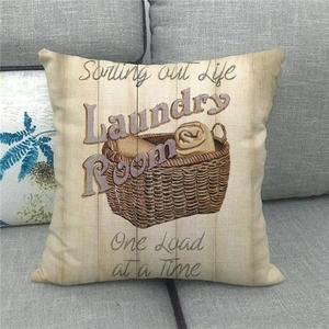 Detailed texture of vintage linen pillowcase with laundry themed typography on a sofa
