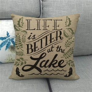 Detail of linen pillow cover texture with LIFE is BETTER at the Lake text and leaf print