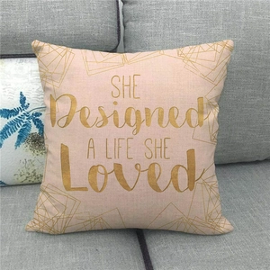 Detail of pink linen pillowcase with gold geometric patterns and inspirational quote text