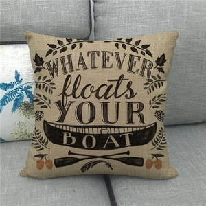 Detail of linen pillowcase fabric with vintage quote on a gray sofa setting
