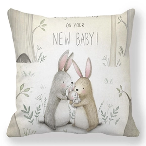Detail of soft peach skin cushion cover with watercolor bunnies and new baby greeting
