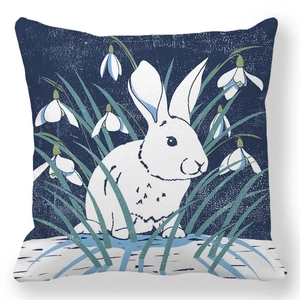 Detailed close-up of a realistic white rabbit illustration on a blue decorative pillowcase