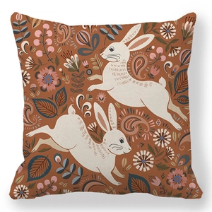 Detail of artistic Easter pillowcase with white rabbits and floral paisley patterns