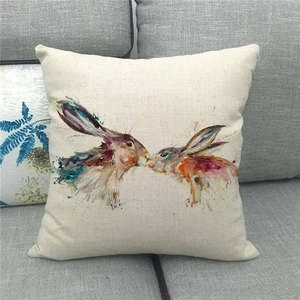 Macro detail of the woven linen texture and rabbit watercolor print on the cushion cover