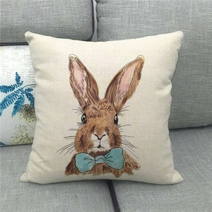 Detail of linen pillowcase featuring a hand-painted rabbit with a light blue bow
