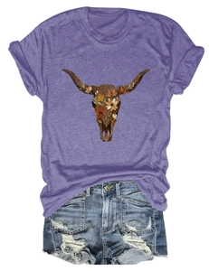 Close-up of bohemian cow skull floral print on purple cotton t-shirt with denim shorts