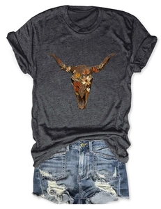 Flat lay of a grey short sleeve T-shirt with a floral buffalo skull print and denim shorts