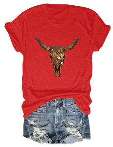 Flat lay of red T-shirt with bull skull floral print and ripped denim shorts