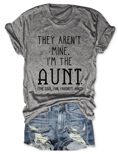 Flat lay of heather gray t-shirt with aunt slogan and ripped denim shorts for casual style