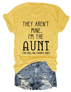 Detail of ginger yellow crew neck tee with text paired with ripped denim shorts
