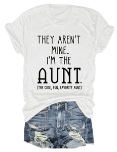 Flat lay of a white crew neck T-shirt with black letter print and ripped denim shorts