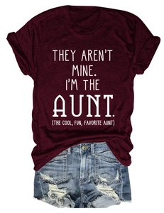 Detail of wine red crew neck t-shirt with white graphic slogan and ripped denim shorts