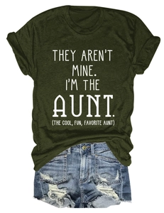 Flat lay of an olive green crew neck T-shirt with white text and ripped denim shorts