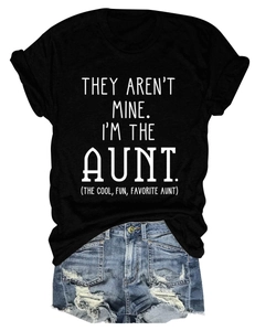 Flat lay of a black crew neck T-shirt with white text and ripped denim shorts for summer