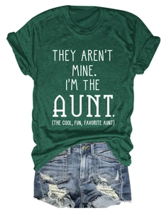 Flat lay of dark green crewneck t-shirt with white quote and vintage denim shorts