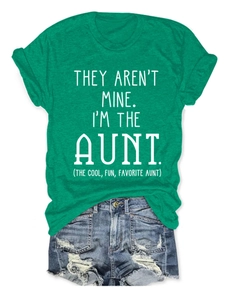 Flat lay of bright green crewneck T-shirt with slogan and ripped denim shorts set