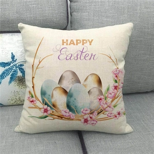 Detail of Happy Easter linen pillowcase with colorful eggs and flowers on a grey sofa