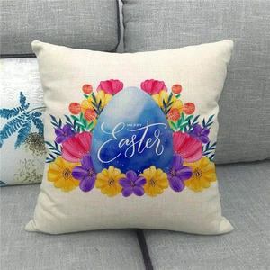 Linen Happy Easter pillow cover with blue egg and flowers on a grey sofa