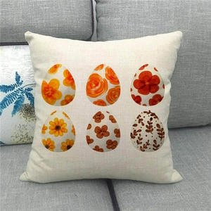 Detail of linen pillowcase featuring six Easter eggs with floral patterns on a sofa