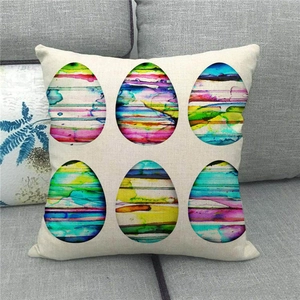 Close-up of Easter linen pillowcase with watercolor egg patterns on a gray sofa