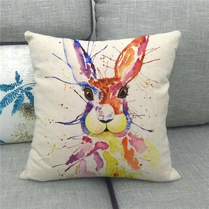 Easter rabbit watercolor throw pillow cover in linen fabric on a grey sofa display