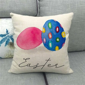Close-up of linen Easter pillowcase with watercolor eggs on a grey sofa in home setting