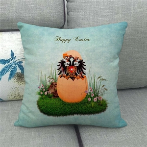 Close-up of linen Happy Easter pillowcase with colorful egg print on a grey fabric sofa
