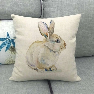 Detailed texture of linen cushion cover with watercolor Easter bunny print on gray sofa