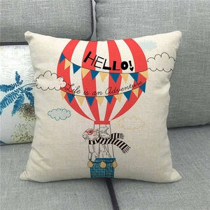Detail of linen cushion cover featuring a rabbit in a hot air balloon and adventure quote