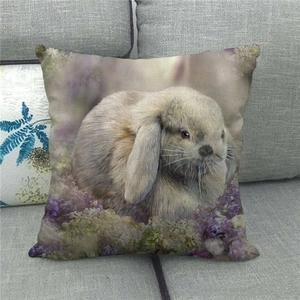 Close-up of linen cushion cover featuring a realistic bunny with purple floral accents