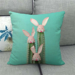 Detailed texture of linen cushion cover with cute cactus and pink rabbit on blue fabric