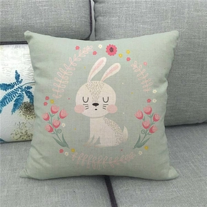 Detail of linen pillowcase with cute bunny and floral wreath pattern on green background