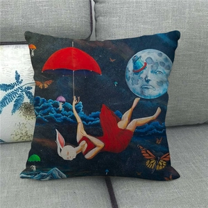Artistic linen pillowcase with moon and rabbit print on a modern grey fabric sofa