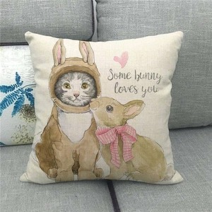 Detailed view of linen cushion cover with cat and bunny print on a grey sofa