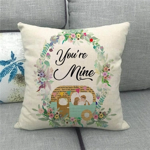 Detailed close-up of linen pillowcase with floral wreath and vintage camper van print