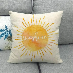Linen blend throw pillow cover with yellow watercolor sun on a grey fabric sofa