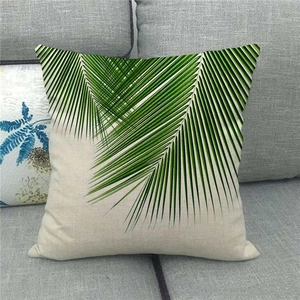 Close-up of tropical palm leaf print on textured linen fabric cushion cover