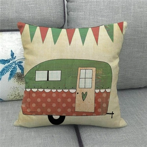 Close-up of linen pillowcase with cartoon camper van illustration on a grey sofa