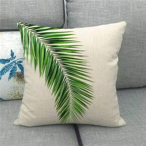 Close-up of tropical palm leaf pattern on a textured linen cotton throw pillow cover