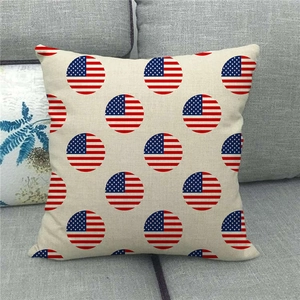Close-up of linen pillowcase with American flag circles on a gray fabric sofa