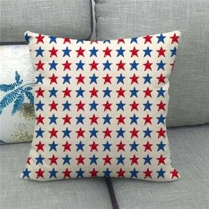 Detail of linen pillowcase with red and blue star pattern on a gray sofa