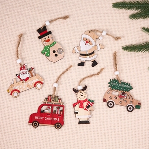 Detailed view of wooden Christmas ornaments featuring Santa and reindeer on white fabric