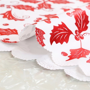 Detail of Christmas table runner featuring red holly berries and festive scalloped edges