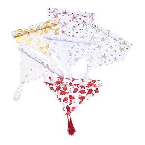 Christmas table runner with festive star and holly patterns and elegant tassels