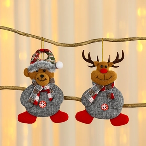 Christmas plush ornaments with teddy bear and reindeer hanging on tree branch