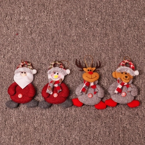 Detail of four Christmas hanging dolls featuring Santa, Snowman, Deer and Bear on fabric