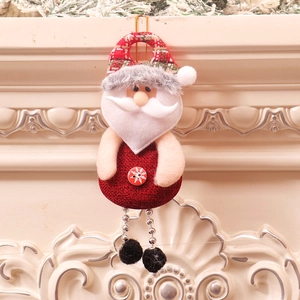 Detail of Santa Claus hanging ornament with red plaid hat and silver bead legs on fireplace