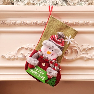 Large Christmas stocking with 3D snowman and Merry Christmas sign hanging on fireplace