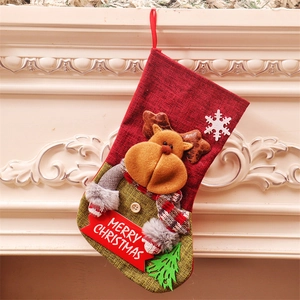 Reindeer Christmas stocking gift bag with Merry Christmas banner on fireplace mantel